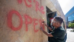 An owner of Shushi Aoi Restaurant, Sarayuth Komol fix plywood frames over the broken window after a night of protests and rioting near the White House in Washington.DC. May 31, 2020.