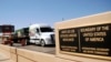 FILE - A truck of the Mexican company Olympics crosses the Puente Internacional Comercio Mundial (World Trade International Bridge) while approaching the border crossing into the U.S., in Laredo.