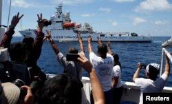 FILE - A Chinese Coast Guard vessel manoeuvres to block a Philippine government supply ship with members of the media aboard at the disputed Second Thomas Shoal, part of the Spratly Islands, in the South China Sea.