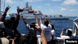 FILE - A Chinese Coast Guard vessel manoeuvres to block a Philippine government supply ship with members of the media aboard at the disputed Second Thomas Shoal, part of the Spratly Islands, in the South China Sea.