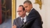 President Barack Obama and French President Francois Hollande embrace during a joint news conference in the East Room of the White House in Washington, Nov. 24, 2015.