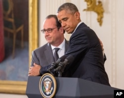 President Barack Obama and French President Francois Hollande embrace during a joint news conference in the East Room of the White House in Washington, Nov. 24, 2015.