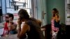 A woman talks on the phone at a coffee shop, in Havana, Cuba, March 15, 2016. Five days ahead of the first presidential trip to Havana in nearly 90 years, the U.S. eliminated a ban on Cuban access to the international banking system. 