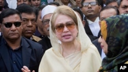 FILE - Bangladesh's former prime minister and opposition leader Khaleda Zia, center, leaves after a court appearance in Dhaka, Dec. 28, 2017.
