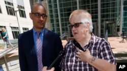 Dana Zzyym of Fort Collins, Colo., right, talks about the arguments in a hearing on Zzyym's lawsuit requiring people to pick a gender to get a passport outside the U.S. Federal Courthouse in Denver, July 20, 2016.