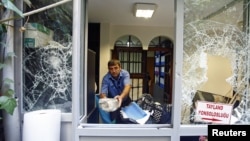 A man removes stones at the Thai honorary consulate in Istanbul, Turkey, July 9, 2015.