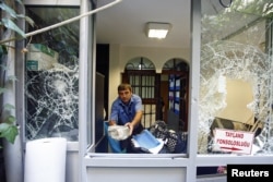 A man removes stones at the Thai honorary consulate in Istanbul, Turkey, July 9, 2015.