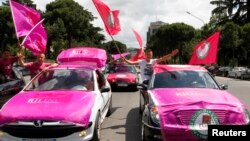 Supporters of Albania's Socialist Party in cars wave their party flags and celebrate along a street in Tirana, June 25, 2013, after counting results show a clear lead for their party. 