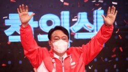 FILE - Former prosecutor general Yoon Seok-yeol from South Korea's main opposition People Power Party waves after being chosen as the party's candidate in next year's presidential election in Seoul on Nove. 5, 2021.