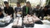 FILE - Thai policemen display intercepted drugs - 226 kilograms (498 pounds) of crystal meth and 8 kilograms (18 pounds) of heroin - during press a conference in Bangkok, Thailand.