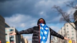 FILE - A supporter celebrates after Joe Biden was sworn in as the 46th U.S. president, at Black Lives Matter Plaza in Washington, Jan. 20, 2021. A year later, some of Biden’s most loyal supporters are frustrated about 2020 campaign promises not realized.