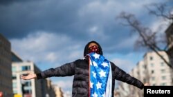 FILE - A supporter celebrates after Joe Biden was sworn in as the 46th U.S. president, at Black Lives Matter Plaza in Washington, Jan. 20, 2021. A year later, some of Biden’s most loyal supporters are frustrated about 2020 campaign promises not realized.