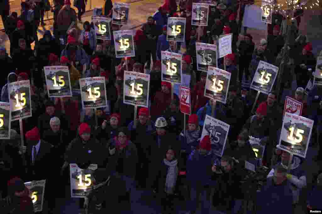 Demonstrators stage a rally after a long march from Sea-Tac to raise the hourly minimum wage to $15 for fast-food workers at City Hall in Seattle, Washington, Dec. 5, 2013.