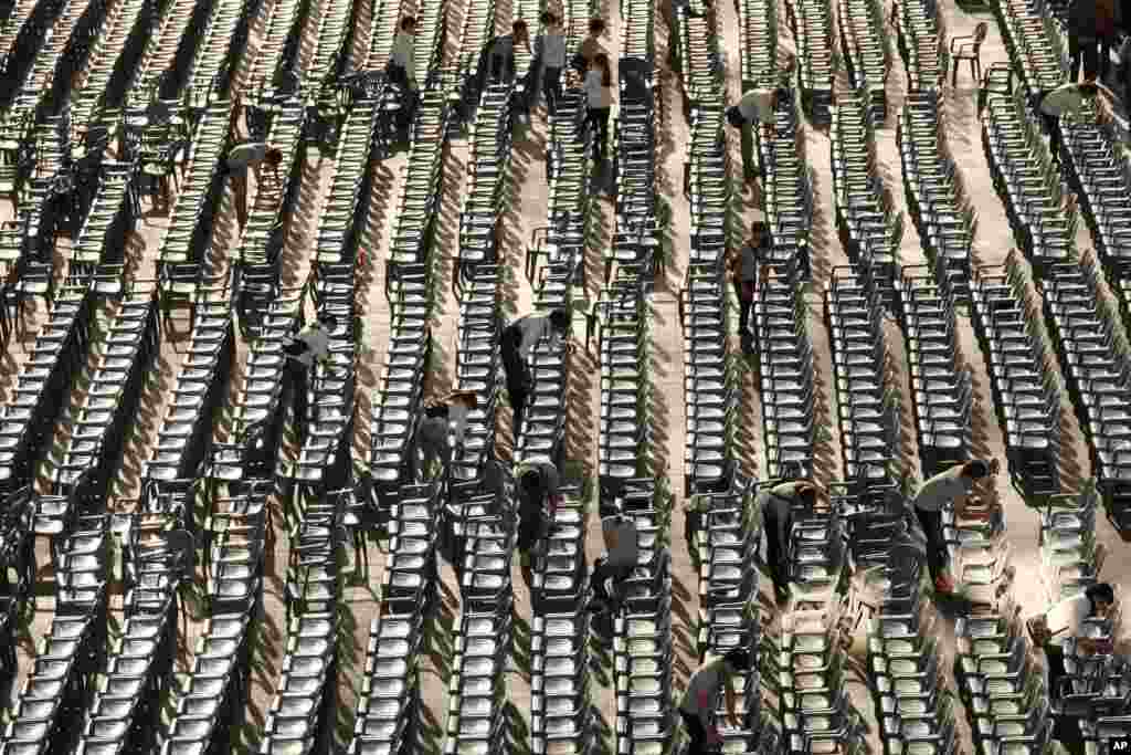 Volunteers clean the chairs at Busan Cinema center where the Busan International Film Festival screenings are held in Busan, south of Seoul, South Korea. 