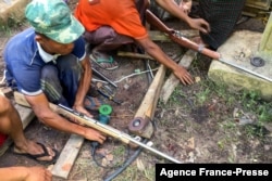 FILE - Members of the People's Defense Force (PDF) make handmade guns to be used in their fight against security forces, near Demoso, Kayah state, Myanmar, as the country remains in turmoil after the February military coup.