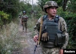 Ukrainian servicemen are seen at their positions on the front line near Avdeyevka, Ukraine, August 10, 2016.