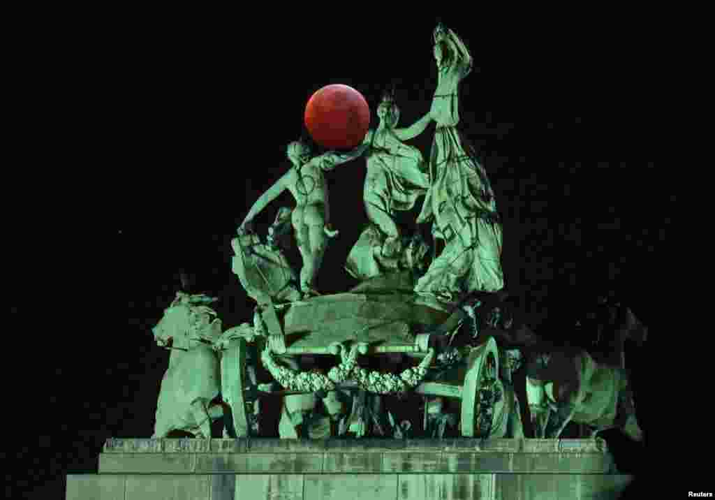 The moon is seen on the top of the Cinquantenaire arch during a total lunar eclipse, known as the &quot;Super Blood Wolf Moon&quot;, in Brussels, Belgium.