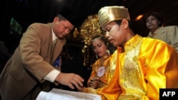 An Indonesian couple takes part in a mass interfaith wedding ceremony sponsored by an organizer and the Jakarta government in Jakarta on July 19, 2011.