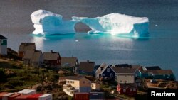 FILE - An iceberg floats near a harbor in the town of Kulusuk, east Greenland, Aug. 1, 2009.