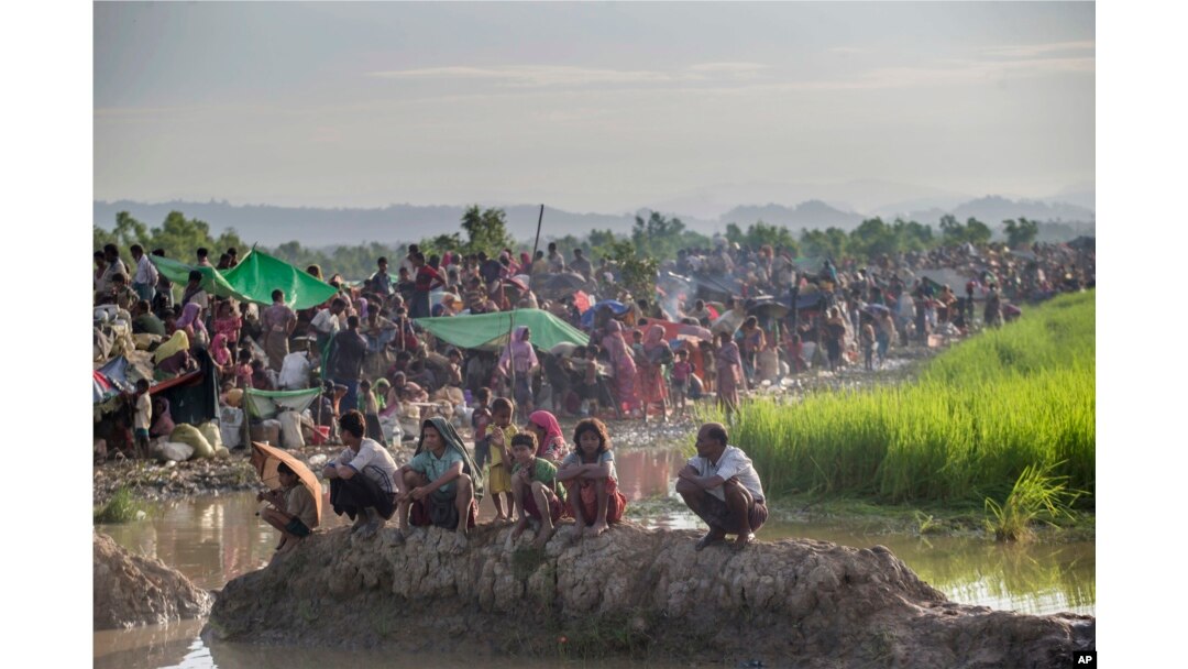 Newly arrived Rohingya Muslims, who crossed over from Myanmar, are seen in a field as Bangladesh border guard soldiers prevent them from moving towards refugee camps, at Palong Khali, Bangladesh, Oct. 17, 2017.