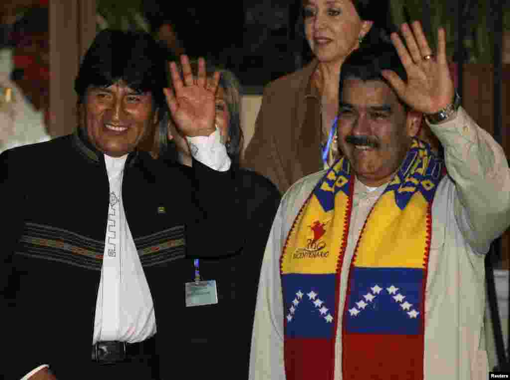 Bolivia's President Evo Morales and his Venezuelan counterpart Nicolas Maduro wave during a meeting in Cochabamba, July 4, 2013.