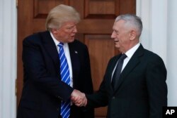 FILE - President-elect Donald Trump shakes hands with retired Marine Corps Gen. James Mattis as he leaves Trump National Golf Club Bedminster clubhouse in Bedminster, N.J., Nov. 19, 2016.