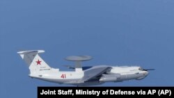 This image released by Joint Staff, Ministry of Defense, shows Russian A-50 airborne early warning and control aircraft flying near the Korean-controlled island called Takeshima in Japanese Tuesday, July 23, 2019.