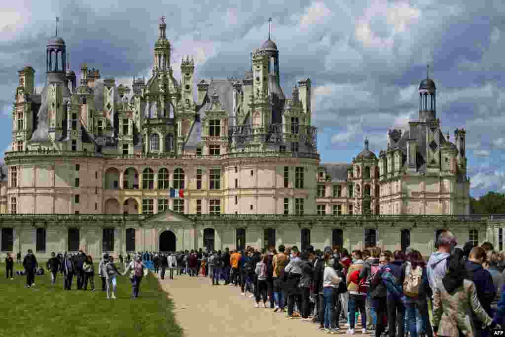 Visitors queue outside of the castle of Chambord in Chambord, central France as the country eases up the measures to curb the spread of the Covid-19.