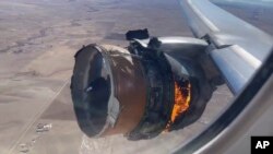 In this image taken from video, the engine of United Airlines Flight 328 is on fire after after experiencing "a right-engine failure" shortly after takeoff from Denver International Airport, Saturday, Feb. 20, 2021, in Denver, Colo. (Chad Schnell via AP)