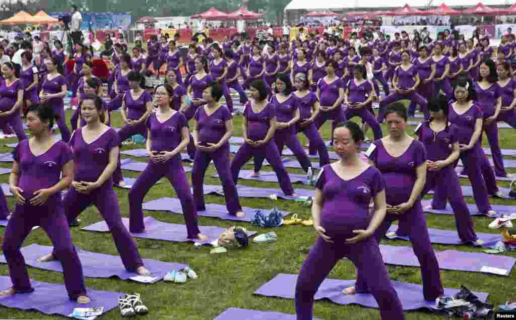 Pregnant women practice yoga as they attempt to break the Guinness World Record for the largest prenatal yoga class, in Changsha, Hunan province, China, June 8, 2014. A total of 505 pregnant women participated in a yoga class together for 37 minutes and 28 second, exceeding the current Guinness World Record set in Shenzhen in 2013 with 423 women, local media reported.