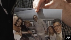 Former Venezuelan Vice President Elias Jaua shows a picture of Cuba's leader Fidel Castro, third from left, at the Hotel Nacional in Havana Sunday Oct. 21, 2012.