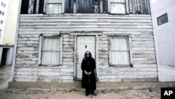 FILE - Rhea McCauley, a niece of the late civil rights icon Rosa Parks, poses in front of Parks' rebuilt house in Berlin, Germany, April 6, 2017.