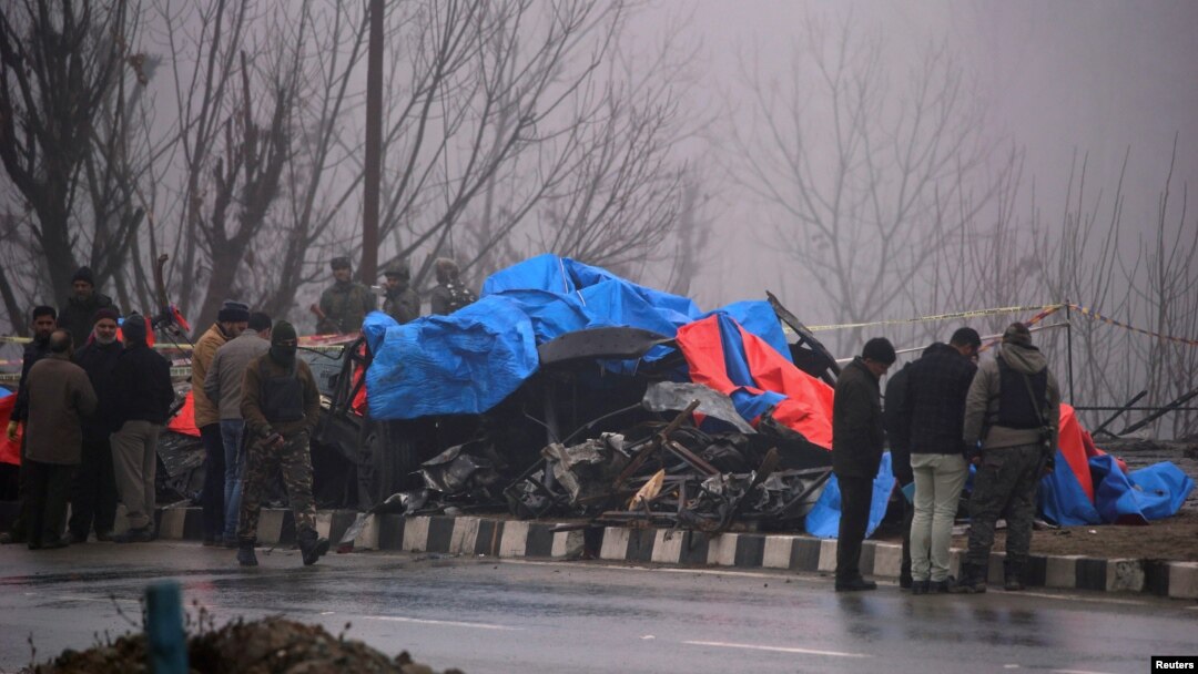 Forensic officials inspect the wreckage of a bus after a suicide bomber rammed a car into the bus carrying Central Reserve Police Force (CRPF) personnel Thursday, in Lethpora in south Kashmir's Pulwama district, Feb. 15, 2019.