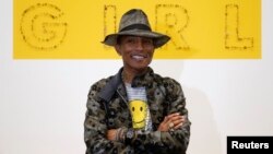 Pharrell Williams poses during the opening of the exhibition "GIRL" at the Galerie Perrotin in Paris, France, May 26, 2014. 