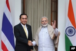 Thailand's Prime Minister Prayuth Chan-ocha, left, and Indian Prime Minister Narendra Modi pose for the media ahead of their meeting in New Delhi, India, Jan. 25, 2018.