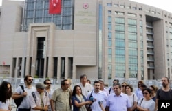 Journalist gather outside a court building in Istanbul, Turkey, to support their colleague journalist Bulent Mumay, who was detained in connection with the investigation launched into the failed coup attempt, July 27, 2016.