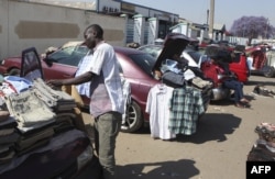 FILE - Hawkers sell goods on the streets of Harare, Sept. 17, 2015.