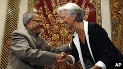 Indian Finance Minister Pranab Mukherjee greets his French counterpart Christine Lagarde in New Delhi, India, Tuesday, June 7, 2011