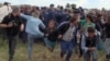 Hungarian TV Station Fires Camerawoman for Tripping, Kicking Migrants 