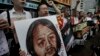 Protesters raise picture of Chinese dissident Tan Zuoren during outside Chinese government&#39;s liaison office, Hong Kong, June 9, 2010.