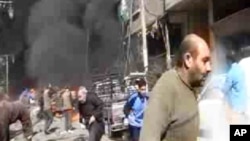 This image taken from video obtained from Ugarit News, which has been authenticated based on its contents and other AP reporting, shows smoke and fire after a fighter jet crashed into a suburb of Damascus, Syria, Feb. 20, 2013.
