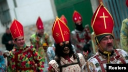 Believer dressed as a "devil" wearing a mask during the "Endiablada" traditional festival in Spain, Feb. 3, 2014.
