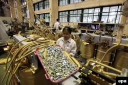 A photograph made available 10 September 2015 shows workers operating at a transformer manufacturing workshop of Dong Anh Electrical Equipment Corporation-Joint Stock Company in Hanoi, Vietnam, 09 September 2015.