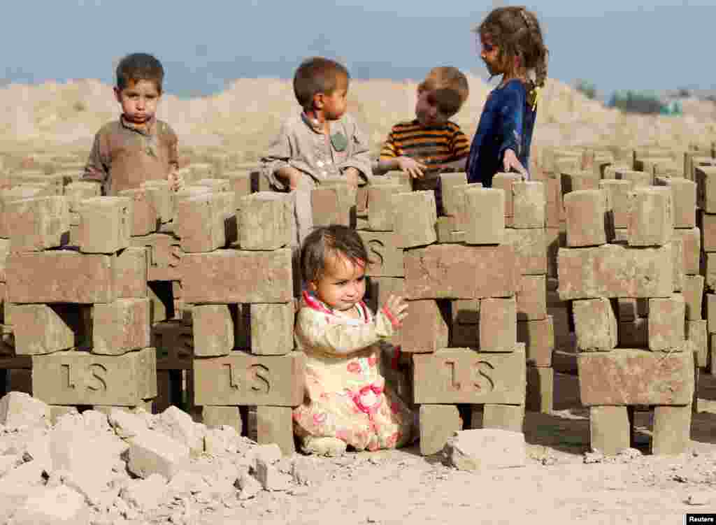 Children play at a brick-making factory on the outskirts of Jalalabad city, eastern Afghanistan.