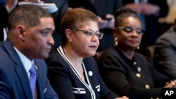 From left, Congressional Black Caucus Chairman Rep. Cedric Richmond, D-La., Rep. Karen Bass, D-Calif., Rep. Gwen Moore, D-Wis., and other members of the Congressional Black Caucus meet with President Donald Trump in the Cabinet Room of the White House, March 22, 2017. 