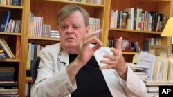 FILE - Garrison Keillor talks at his office in St. Paul, Minnesota, July 26, 2017.