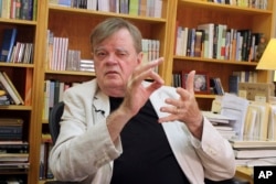 FILE - Garrison Keillor talks at his office in St. Paul, Minnesota, July 26, 2017.