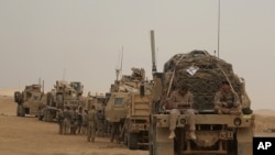 FILE - U.S. Marines prepare to build a military site in western Anbar, Iraq, Nov. 7, 2017.