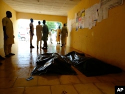 FILE - Family members wait to claim bodies of suicide attack victims at a hospital in Konduga, outside Maiduguri, Nigeria, Aug. 16, 2017. The attack was blamed on Boko Haram militants.