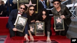 FILE - Maná members Sergio Vallin, from left, Juan Calleros, Alex Gonzalez and Fher Olvera pose together after the Mexican rock band received a star on the Hollywood Walk of Fame, Feb. 10, 2016, in Los Angeles.